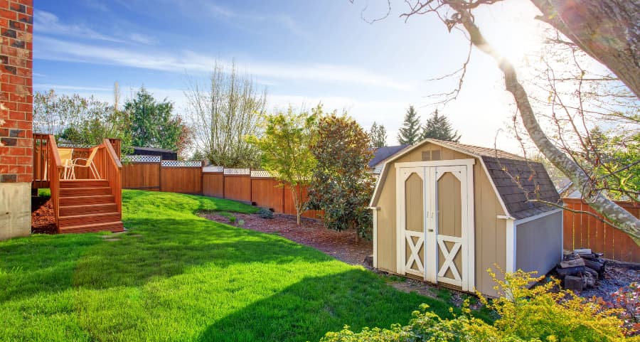 Fenced backyard with storage shed in Tulsa